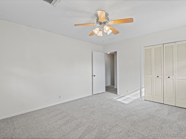 unfurnished bedroom featuring light carpet, ceiling fan, and a closet