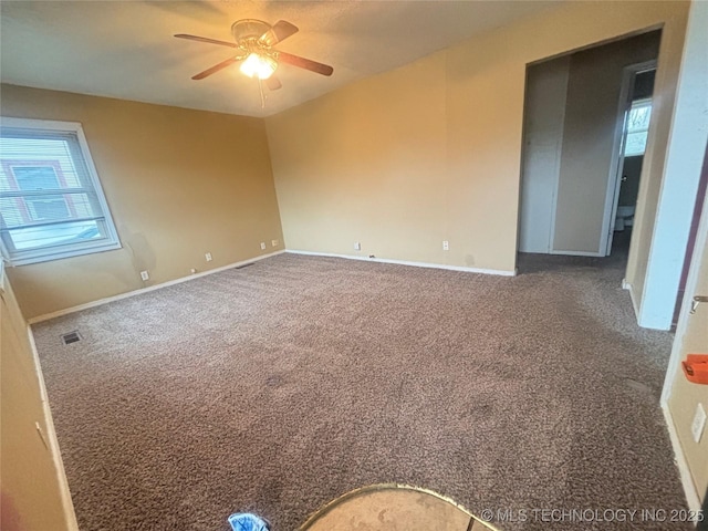 carpeted spare room featuring ceiling fan