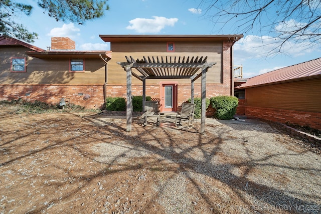 rear view of house featuring a pergola