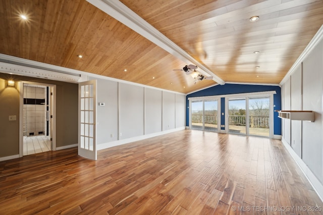 unfurnished living room with hardwood / wood-style flooring, lofted ceiling with beams, wooden ceiling, and french doors