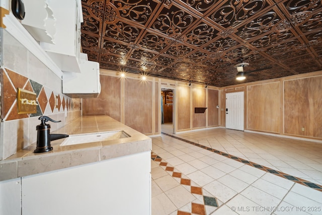 interior space featuring light tile patterned flooring and sink