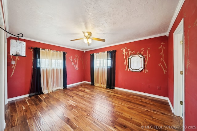 spare room with hardwood / wood-style flooring, ceiling fan, ornamental molding, and a textured ceiling