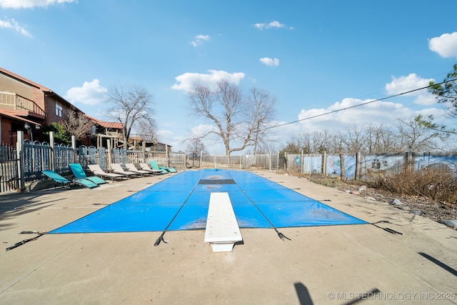 view of swimming pool featuring a water view and a patio area