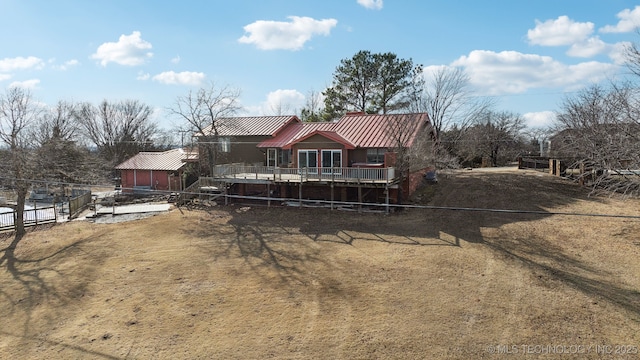 rear view of house featuring a deck