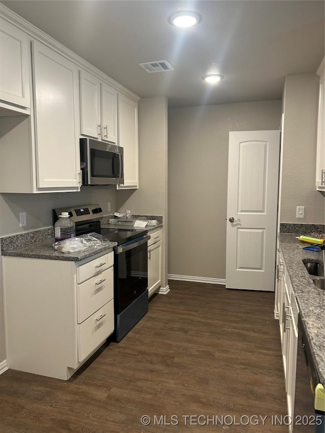 kitchen with white cabinetry, visible vents, appliances with stainless steel finishes, and dark wood finished floors