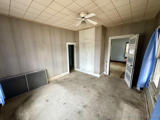 unfurnished bedroom with ceiling fan, carpet flooring, and a closet