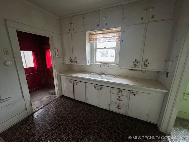 kitchen featuring sink and white cabinets