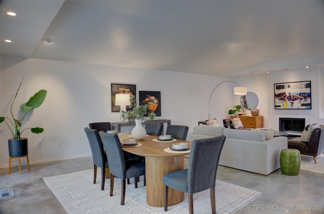 2411 E 72nd Pl Unit 2-A-3, Tulsa, OK 74136 - dining area with finished concrete floors, recessed lighting, a fireplace, and lofted ceiling