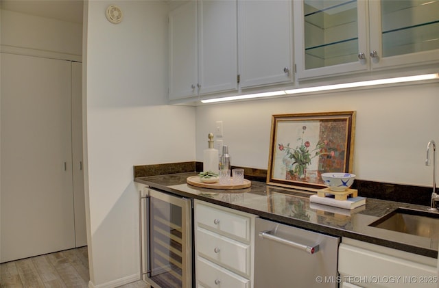 2411 E 72nd Pl Unit 2-A-3, Tulsa, OK 74136 - indoor dry bar featuring beverage cooler, light wood-type flooring, and stainless steel dishwasher