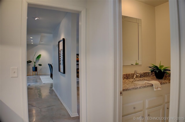 2411 E 72nd Pl Unit 2-A-3, Tulsa, OK 74136 - hallway featuring finished concrete floors and a sink