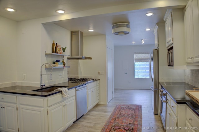 2411 E 72nd Pl Unit 2-A-3, Tulsa, OK 74136 - kitchen featuring island exhaust hood, appliances with stainless steel finishes, dark countertops, light wood-type flooring, and recessed lighting