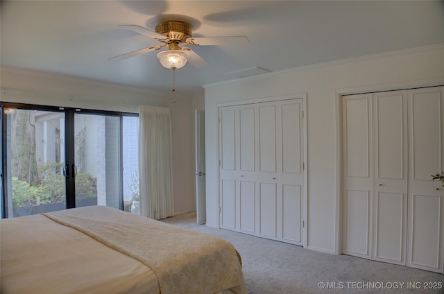 2411 E 72nd Pl Unit 2-A-3, Tulsa, OK 74136 - bedroom with multiple closets, crown molding, light carpet, and ceiling fan
