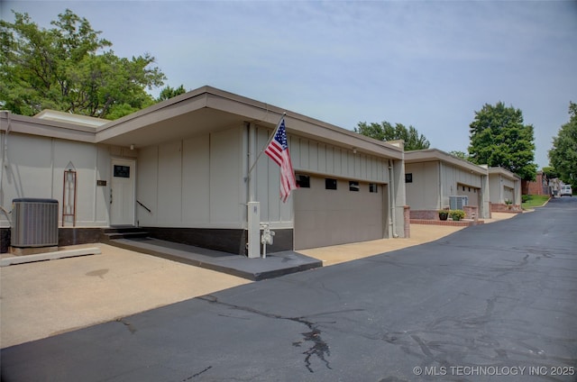 2411 E 72nd Pl Unit 2-A-3, Tulsa, OK 74136 - view of property exterior with entry steps and board and batten siding