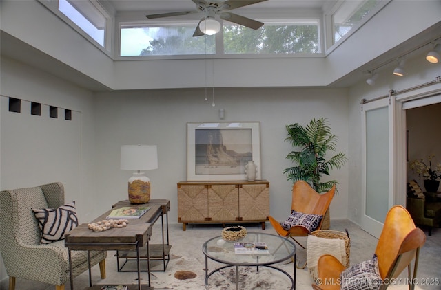 2411 E 72nd Pl Unit 2-A-3, Tulsa, OK 74136 - sitting room with a skylight, a towering ceiling, a barn door, and ceiling fan