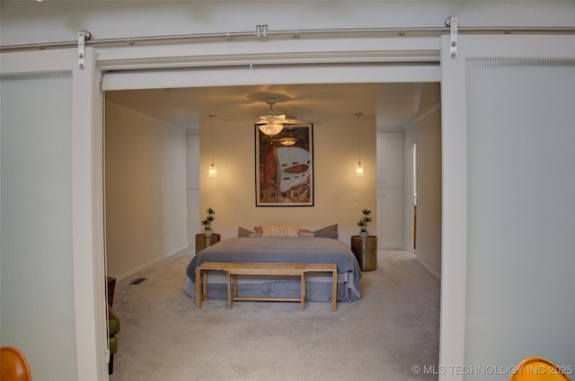 2411 E 72nd Pl Unit 2-A-3, Tulsa, OK 74136 - carpeted bedroom with a barn door and baseboards