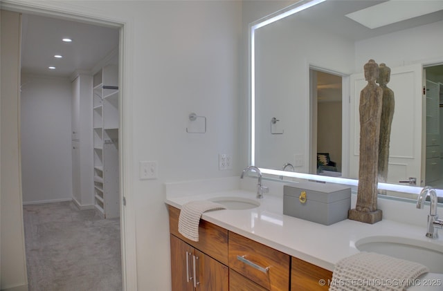 2411 E 72nd Pl Unit 2-A-3, Tulsa, OK 74136 - full bath with double vanity, a spacious closet, and recessed lighting