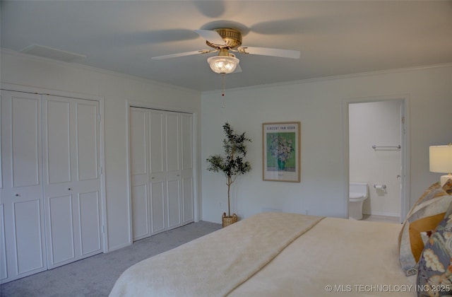 2411 E 72nd Pl Unit 2-A-3, Tulsa, OK 74136 - bedroom with two closets, crown molding, carpet, connected bathroom, and ceiling fan