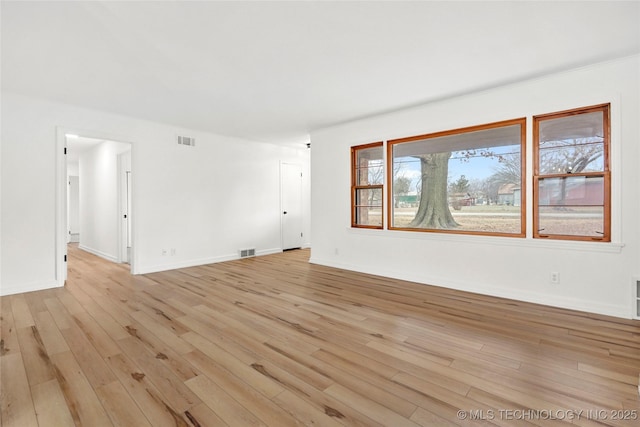 spare room with light hardwood / wood-style flooring