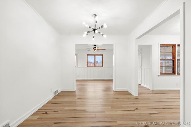 interior space featuring crown molding, ceiling fan with notable chandelier, and light wood-type flooring