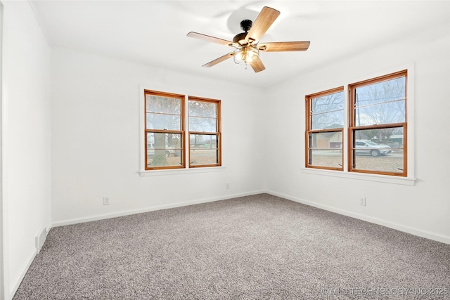 carpeted spare room with ceiling fan