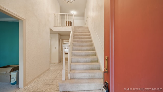 stairway with tile patterned floors