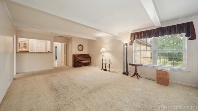 carpeted empty room with beamed ceiling and ornamental molding