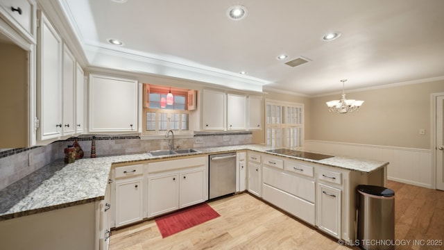 kitchen with pendant lighting, kitchen peninsula, sink, and white cabinets