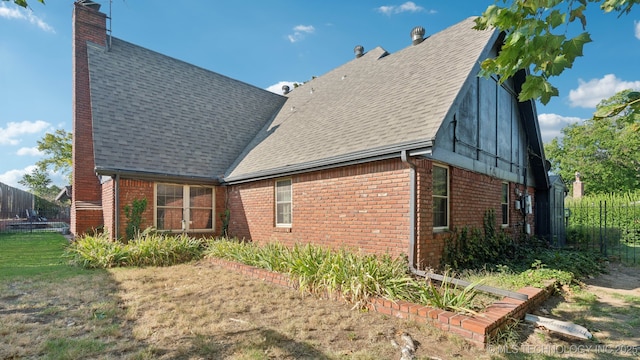 rear view of property featuring a yard