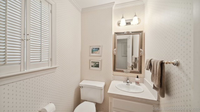 bathroom with crown molding, vanity, and toilet