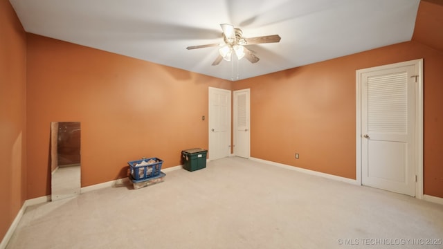 empty room featuring carpet floors and ceiling fan