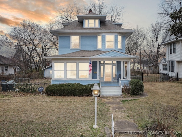 view of front of house with a yard and covered porch