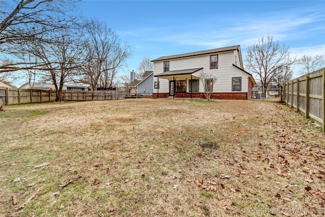 rear view of property with cooling unit and a lawn