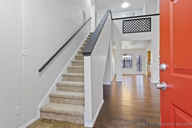 entryway featuring a notable chandelier and wood-type flooring