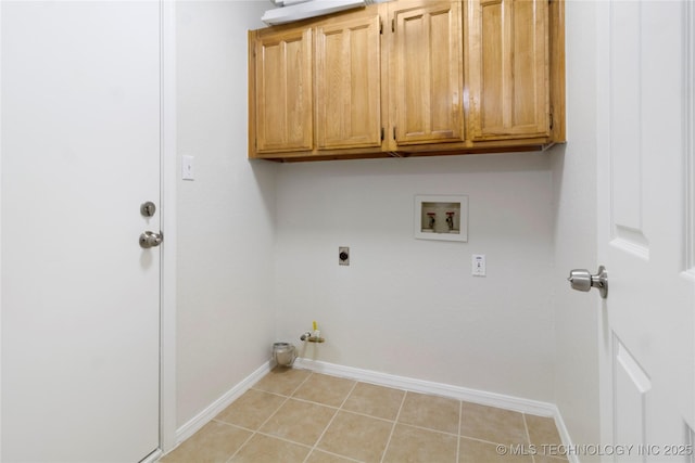 laundry room with gas dryer hookup, light tile patterned floors, electric dryer hookup, cabinets, and washer hookup