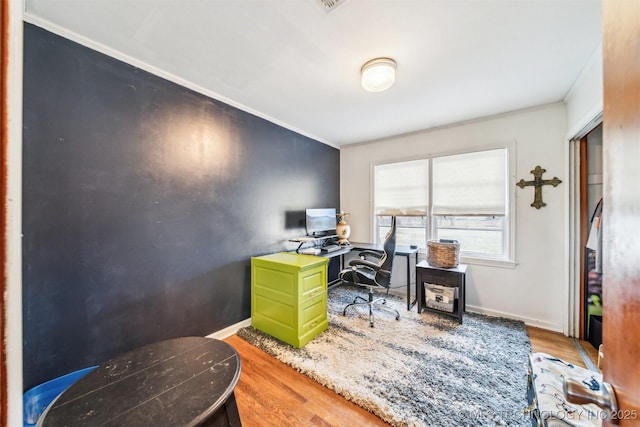 office area with hardwood / wood-style floors and crown molding