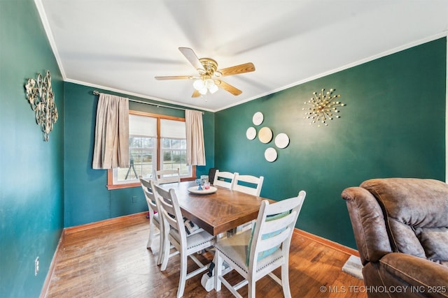 dining area featuring crown molding, ceiling fan, and hardwood / wood-style floors