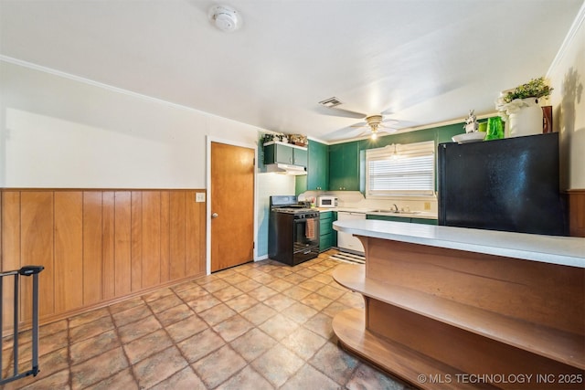 kitchen featuring sink, ceiling fan, ornamental molding, black appliances, and green cabinetry