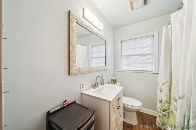 bathroom with vanity, wood-type flooring, and toilet