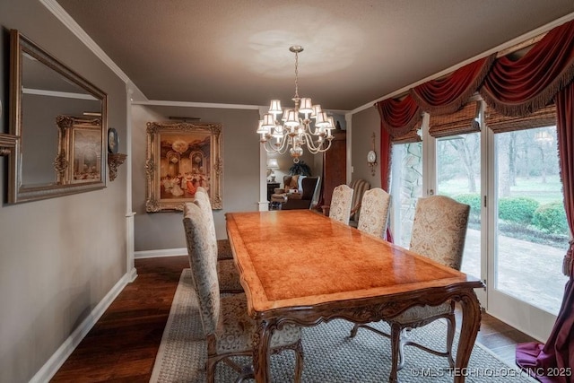 dining area with ornamental molding, baseboards, a notable chandelier, and dark wood finished floors