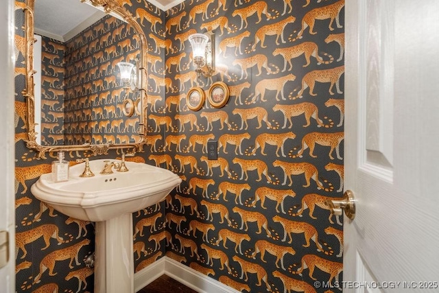bathroom featuring baseboards and crown molding