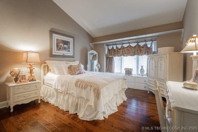 bedroom featuring dark wood-style floors and lofted ceiling