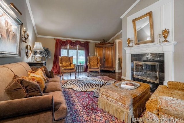 living room with ornamental molding, wood finished floors, vaulted ceiling, and a premium fireplace