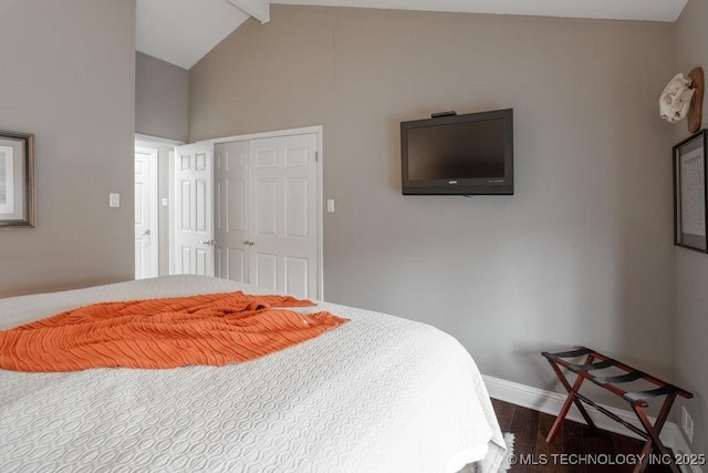 bedroom featuring dark wood-type flooring, lofted ceiling with beams, and baseboards