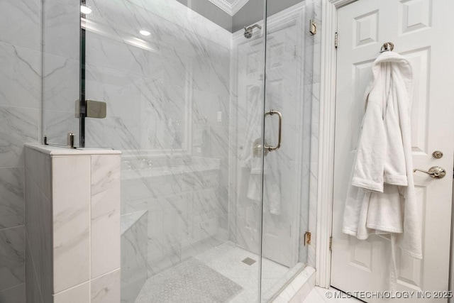full bathroom featuring a marble finish shower and ornamental molding