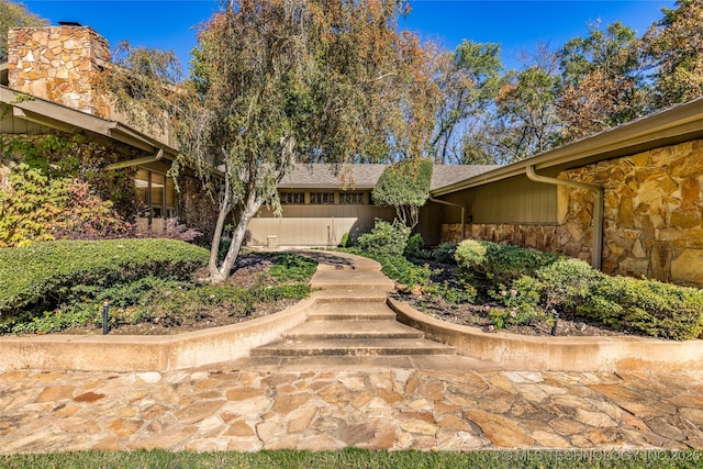 exterior space featuring stone siding