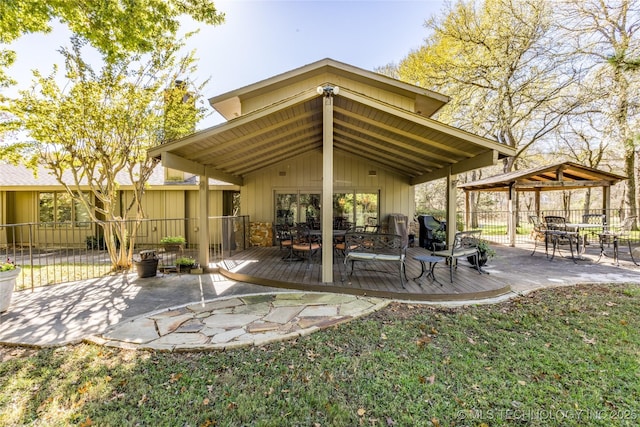 view of patio with a gazebo, fence, a deck, and outdoor dining area