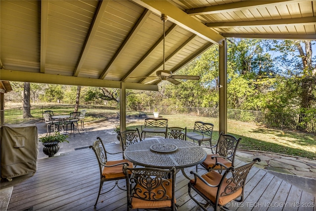 deck with ceiling fan, fence, and outdoor dining area