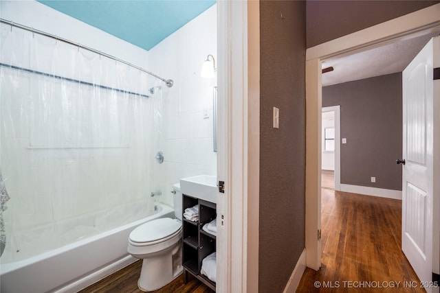 bathroom featuring toilet, wood-type flooring, and shower / bath combo with shower curtain