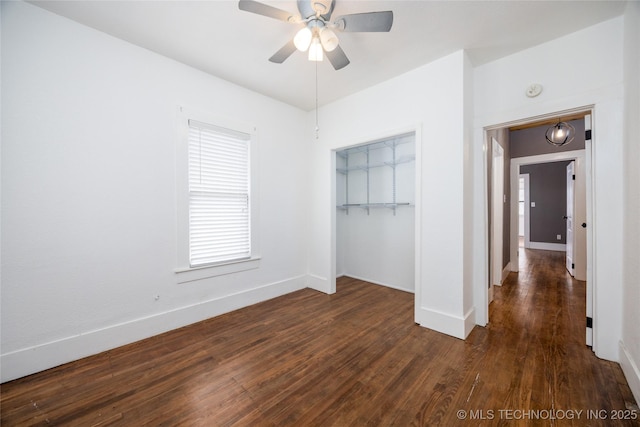 unfurnished bedroom with dark wood-type flooring, ceiling fan, and a closet