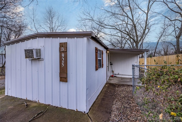 view of outdoor structure with a wall mounted AC